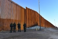 US-POLITICS-WALL-MIGRANTS-immigration-illegal-immigrants Border Patrol officers wait for US Department of Homeland Security Secretary Kirstjen M. Nielsen to inaugurate the first completed section of President Trumps 30-foot border wall in the El Centro Sector, at the US Mexico border in Calexico, California on October 26, 2018. (Photo by Mark RALSTON / AFP) (Photo …