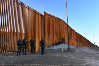 Border Patrol officers wait for US Department of Homeland Security Secretary Kirstjen M. N