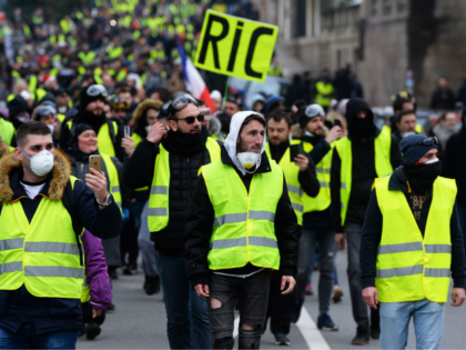 A protester holds a placard reading RIC, the acronym for 'Citizens Initiated Referend