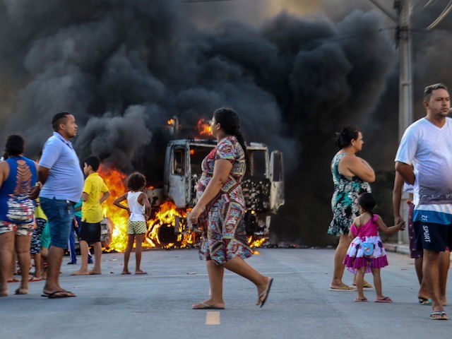 This picture released by O Povo shows a truck burning during a wave of gang violence in Brazil's northeastern Ceara state, in the Conjunto Palmeiras neighborhood, city of Fortaleza, Ceara state, Brazil on January 3, 2019. - Brazil's government ordered troops to the northeast of the country on Friday to …