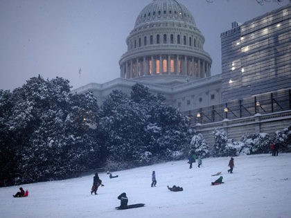 People sled on Capitol Hill during a winter storm January 13, 2019 in Washington, DC. - Washington area residents woke up to a winter wonderland, and may need to shovel aside several inches of snow that fell overnight as a winter storm warning remains in effect until 6 p.m. Sunday …