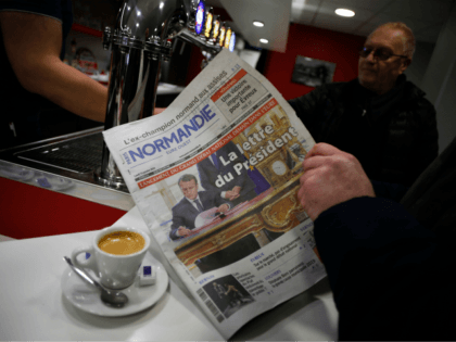 A resident of Bourgtheroulde-Infreville reads on January 14, 2019 a newspaper whose front