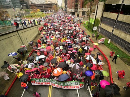 Thousands of teachers march in the rain through Los Angeles, California on January 14, 201