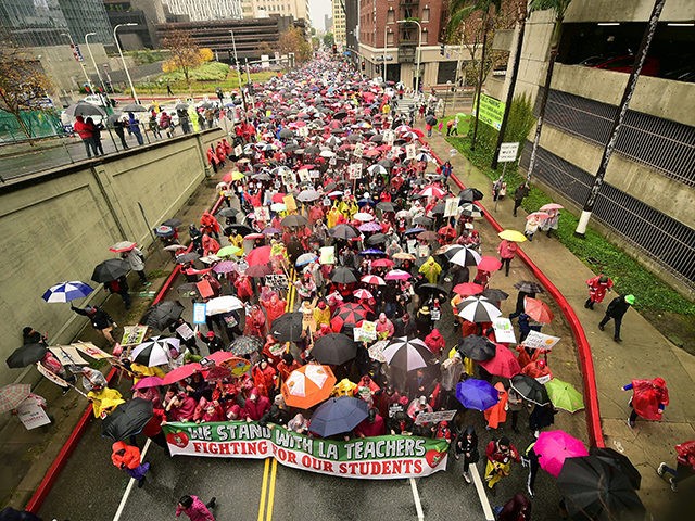 Thousands of teachers march in the rain through Los Angeles, California on January 14, 2019, on the first day of the first teachers strike in 30 years targeting the Los Angeles Unified School District (LAUSD). - Teachers of the LAUSD, the second largest public school district in the US, are …