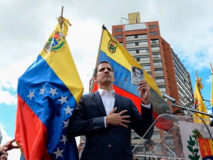 Venezuela's National Assembly head Juan Guaido declares himself the country's "acting president" during a mass opposition rally against leader Nicolas Maduro, on the anniversary of a 1958 uprising that overthrew military dictatorship in Caracas on January 23, 2019. - Moments earlier, the loyalist-dominated Supreme Court ordered a criminal investigation of …