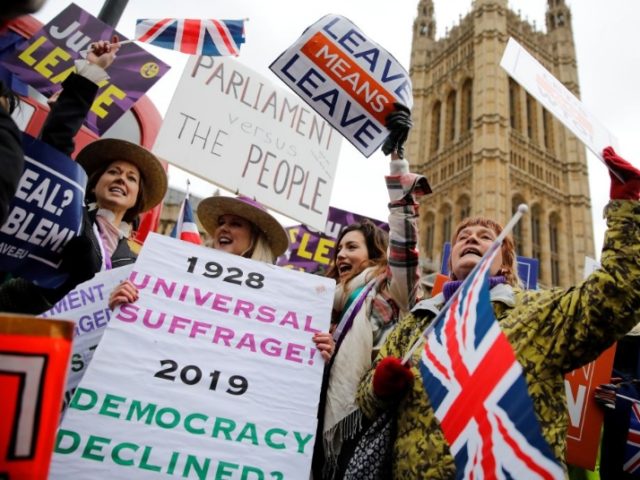 TOPSHOT - Pro-Brexit activists hold placards and wave Union flags as they demonstrate outside of the Houses of Parliament in London on January 29, 2019. - British Prime Minister Theresa May will seek "legal changes" to the Brexit deal she agreed with EU leaders only last month to try to …