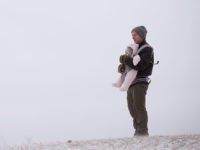CHICAGO, ILLINOIS - JANUARY 19: Carey Wiese and his nine-month-old daughter Hazel watch people sled down a hill in Humboldt Park after a snowstorm passed through the area on January 19, 2019 in Chicago, Illinois. Snowfall in the city and surrounding area ranged between 4 and 10 inches. (Photo by …