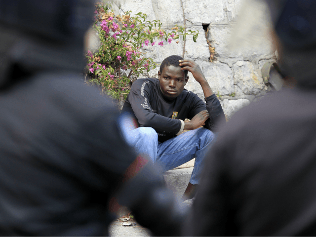 A migrant waits along the road after Italian police broke up their group at the Italy-France border, in Ventimiglia, on June, 13, 2015. The Italian police, wearing riot gear, tried to push the migrants back towards the town of Ventimiglia, five kilometres (three miles) from the border, but a group …