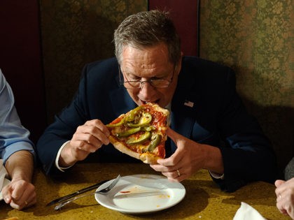 NEW YORK - MARCH 30: GOP Presidential Candidate John Kasich eats a piece of pizza at Gino's Pizzeria and Restaurant on March 30, 2016 in the Queens borough of New York City. Kasich is one of three remaining GOP Presidential Candidates fighting for New York's 95 Republican delegates in the …