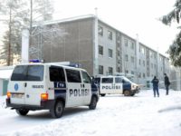 Finnish police gather near buildings whe migrants