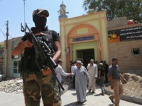 Iraq a Cleric Abroad In this June 20, 2014 file photo, a fighter of the Mahdi Army, formed by Muqtada al-Sadr, stands guards in front of a Shiite mosque after Friday prayers, in the northern oil rich province of Kirkuk, Iraq. Al-Sadr, notorious for his followers’ deadly attacks on U.S. troops in Iraq and …