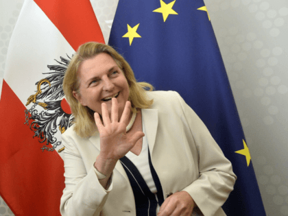 Austria's Foreign Minister Karin Kneissl (R) waves next to Britain's Foreign Minister Jeremy Hunt as they arrive to talk to the press as part of a meeting on August 1, 2018 in Vienna. (Photo by HERBERT PFARRHOFER / APA / AFP) / Austria OUT (Photo credit should read HERBERT PFARRHOFER/AFP/Getty …