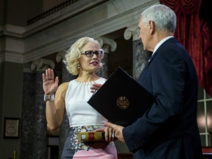 Senator Kyrsten Sinema (D-AZ) participates in a mock swearing in ceremony with Vice President Mike Pence on Capitol Hill on January 3, 2019 in Washington, DC. (Photo by Zach Gibson/Getty Images)