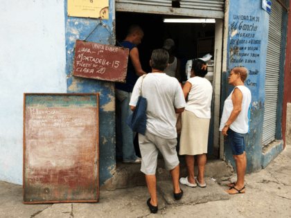 People waiting in line at a libreta store in Havana