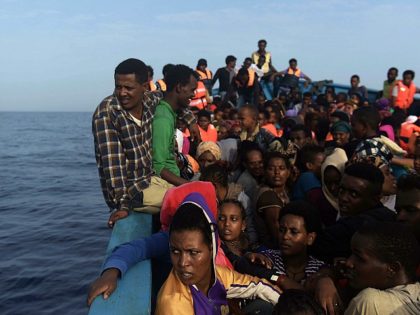 Refugees and migrants wait to be rescued by members of Proactiva Open Arms NGO in the Medi