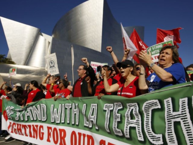 United Teachers Los Angeles leaders are joined by thousands of teachers, who may go on strike against the nation's second-largest school district next month, as they march past the Walt Disney Concert Hall in downtown Los Angeles Saturday, Dec. 15, 2018. The union contends that the district is hoarding a …