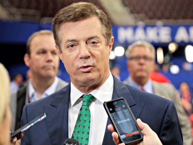 In this July 17, 2016 file photo, Trump Campaign Chairman Paul Manafort talks to reporters on the floor of the Republican National Convention at Quicken Loans Arena in Cleveland as Rick Gates listens at back left. Emails obtained by The Associated Press shed new light on the activities of a …