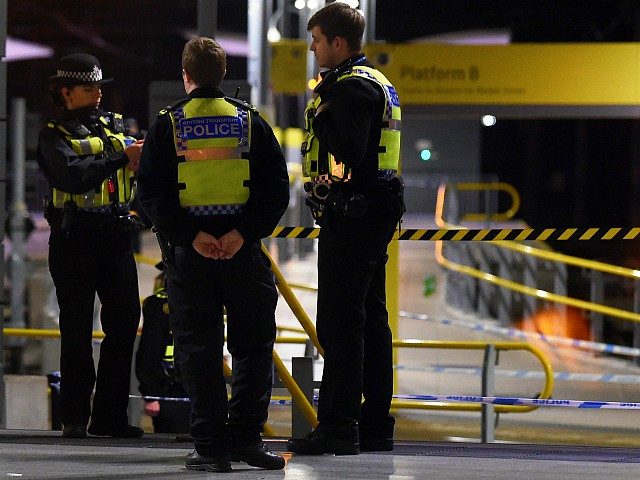 Police officers stand near a cordon at Manchester Victoria Station, in Manchester on January 1, 2019, following a stabbing on December 31, 2018. - A man, a woman and a police officer were being treated for knife injuries, police said Monday, after a stabbing at a railway station in the …
