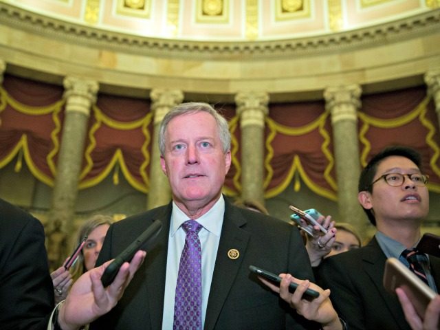 Rep. Mark Meadows, R-N.C., chairman of the House Freedom Caucus, walks as he speaks with r