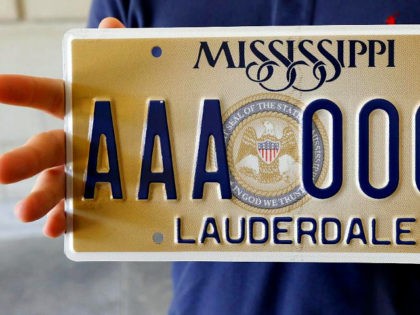 Clay Chandler, director of communications for Gov. Phil Bryant, holds Mississippi's new standard license plate Thursday, May 10, 2018, at the Capitol in Jackson, Miss. It will display the state seal that includes the phrase, "In God We Trust." Republican Gov. Bryant unveiled the new design on Twitter. It will …