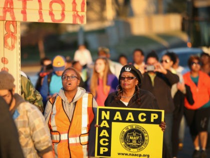 Members of the NAACP and their supporters start out for the first day of Journey for Justice, seven-day 120-mile march from the Canfield Green apartments where Michael Brown was killed to the Governor's mansion in Jefferson City, Missouri on November 29, 2014 in Ferguson, Missouri. The Ferguson area has been …