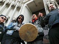 Native American protestors hold hands with parishioner Nathanial Hall, right, during a group prayer outside the Catholic Diocese of Covington Tuesday, Jan. 22, 2019, in Covington, Ky. The diocese in Kentucky has apologized after videos emerged showing students from Covington Catholic High School mocking Native Americans outside the Lincoln Memorial …