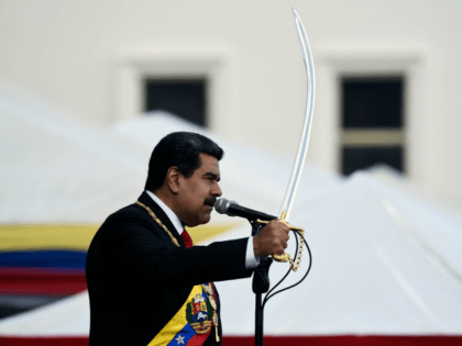 Venezuela's President Nicolas Maduro brandishes a sabre while delivering a speech during t