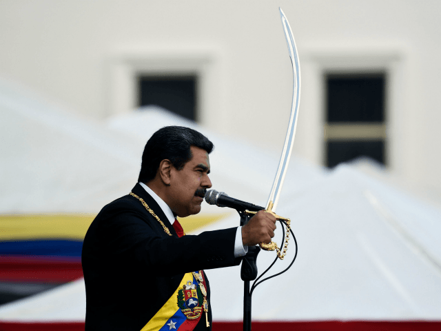 Venezuela's President Nicolas Maduro brandishes a sabre while delivering a speech during the ceremony of recognition by the Bolivarian National Armed Forces (FANB), at the Fuerte Tiuna Military Complex, in Caracas on January 10, 2019. - Maduro begins a new term that critics dismiss as illegitimate, with the economy in …