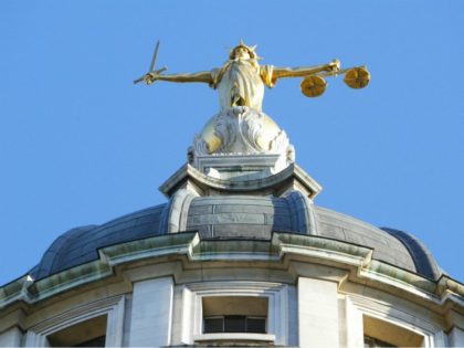 LONDON, UNITED KINGDOM: The statue of justice stands on the copula of the Old Bailey courthouse after Ian Huntley was sentenced to two life terms in prison for murdering 10-year-old school girls Holly Wells and Jessica Chapman and his girl friend Maxine Wells was convicted of preverting the course of …