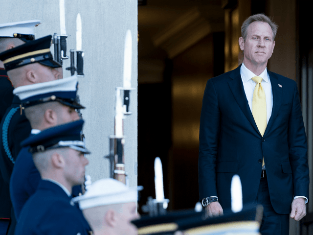 US Deputy Secretary of Defense Patrick Shanahan listens to the US National Anthem during a