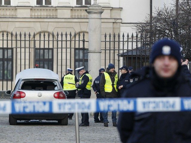 Police officers examine a car in the driveway to the Presidential Palace in Warsaw, Poland