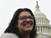 Rep. Rashida Tlaib, D-Mich., smiles following a group photo with the women in the House of Representatives on Capitol Hill in Washington, Friday, Jan. 4, 2019, during the opening session of the 116th Congress. (AP Photo/Susan Walsh)