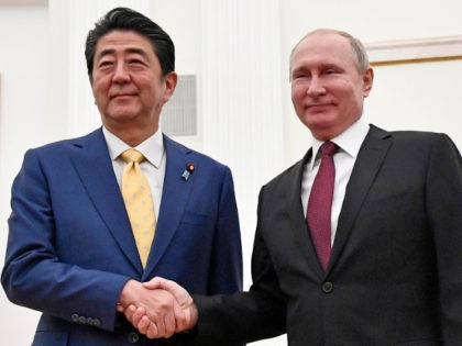 Russian President Vladimir Putin, right, and Japanese Prime Minister Shinzo Abe shake hands prior to their talks in the Kremlin in Moscow, Russia, Tuesday, Jan. 22, 2019.