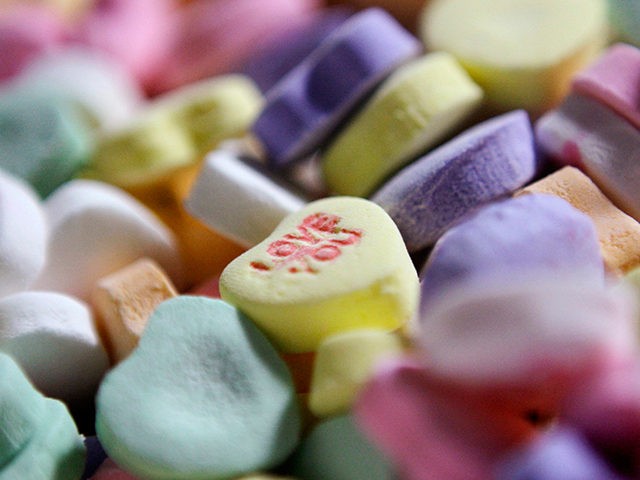 Caption: FILE - In this Jan. 14, 2009 file photo, colored "Sweethearts" candy is held in bulk prior to packaging at the New England Confectionery Company in Revere, Mass. Four bidders are vying to buy the bankrupt manufacturer of Necco Wafers, Sweethearts and other iconic candies. A bankruptcy auction is …