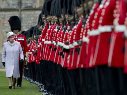 Britain's Queen Elizabeth II (L) inspects the Parade during a ceremony to present New Colo