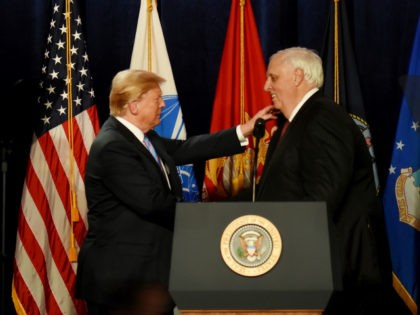 President Donald Trump, left, embraces West Virginia Governor Jim Justice during his remarks at a Salute to Service charity dinner in conjunction with the PGA Tour's Greenbrier Classic at The Greenbrier in White Sulphur Springs, W.Va., Tuesday, July 3, 2018. Trump celebrated active-duty service members and veterans during a military …