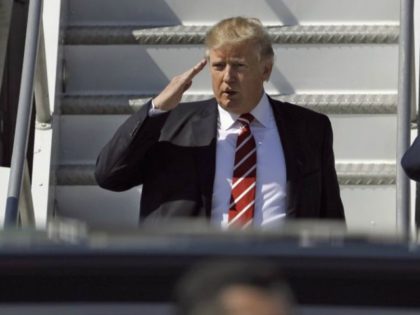 President Donald Trump salutes as he arrives on Air Force One at MacDill Air Force Base, Monday, Feb. 6, 2017, in Tampa, Fla. (AP Photo/Chris O'Meara)