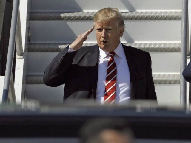 President Donald Trump salutes as he arrives on Air Force One at MacDill Air Force Base, M