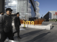 In this Friday, Jan. 4, 2019, photo, Chinese residents pass by a decor marking the new year outside a shopping mall in Beijing. A U.S. delegation led by deputy U.S. trade representative, Jeffrey D. Gerrish arrived in the Chinese capital ahead of trade talks with China. China sounded a positive …