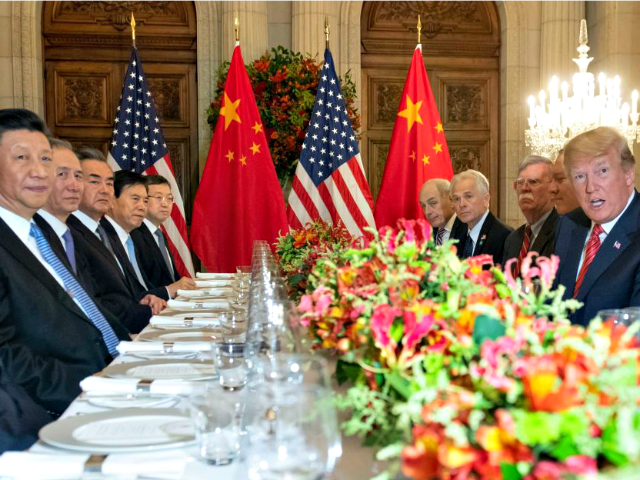 US President Donald Trump (R) and China”s President Xi Jinping (L) along with members of