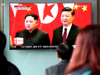 SEOUL, SOUTH KOREA - MARCH 28: South Koreans watch a television broadcast reporting the No