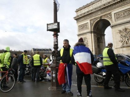 Yellow vest demonstrators gather near the Arc de Triomphe before marching in Paris, Saturd