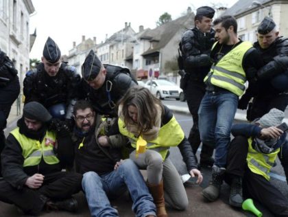 Police remove yellow vest demonstrators staging a sit-down protest in Souillac, southern F