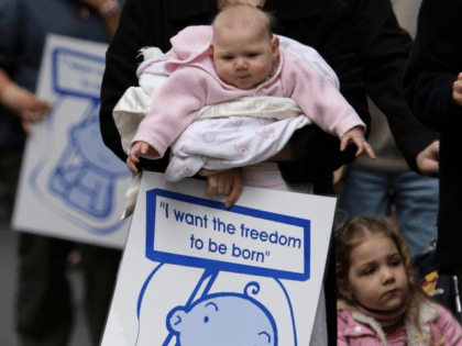A mother and her baby march during a protest on the steps of Parliment House on July 28, 2007 in Melbourne, Australia. The Labour government has attempted to decriminalise abortion, a move which may give medical professionals in Victoria the right not to perform abortions. (Photo by Robert Cianflone/Getty Images)