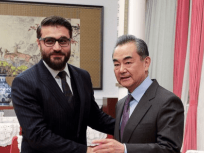 Afghanistan National Security Advisor Hamdullah Mohib, left, shakes hands with Chinese For