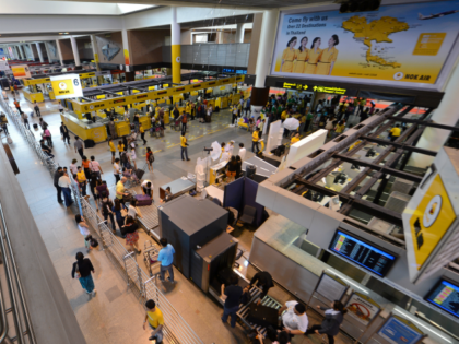 Passengers wait to check-in during the re-opening of Don Mueang Airport in Bangkok on October 1, 2012. Don Muang airport which was hit hard by flooding in 2011, and has been undergoing repairs and construction to prevent another disaster, will handle much of the low-cost air traffic in Thailand beginning …
