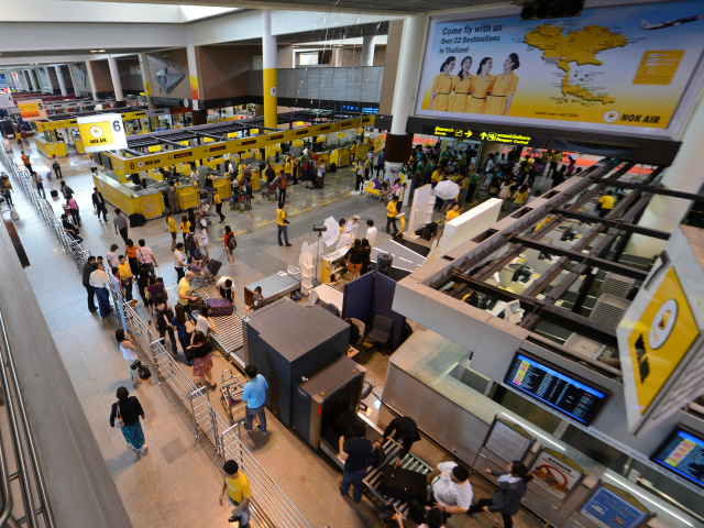 Passengers wait to check-in during the re-opening of Don Mueang Airport in Bangkok on Octo