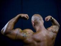 body-building-competition-ap In this Thursday, Oct. 18, 2018 photo, a contestant exercises backstage during the National Amateur Body Builders' Association competition in Tel Aviv, Israel. Exhausted from weeks of strict dieting and last-minute exertions, the muscle-bound athletes primped, painted and prepped before taking the stage. (AP Photo/Oded Balilty)