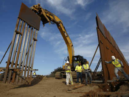 Construction crews install new border wall sections Wednesday, Jan. 9, 2019, seen from Tij