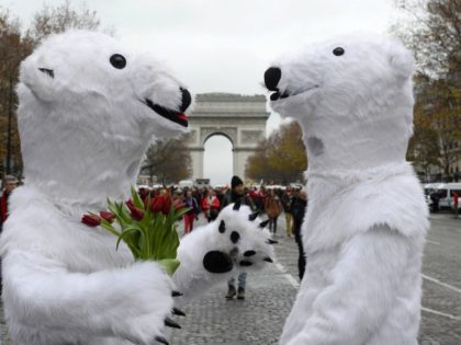 TOPSHOT - Activists dressed as polar bears are pictured as activists gather for a demonstration to form a giant red line at the Avenue de la Grande armee boulevard in Paris on December 12, 2015, as a proposed 195-nation accord to curb emissions of the heat-trapping gases that threaten to …